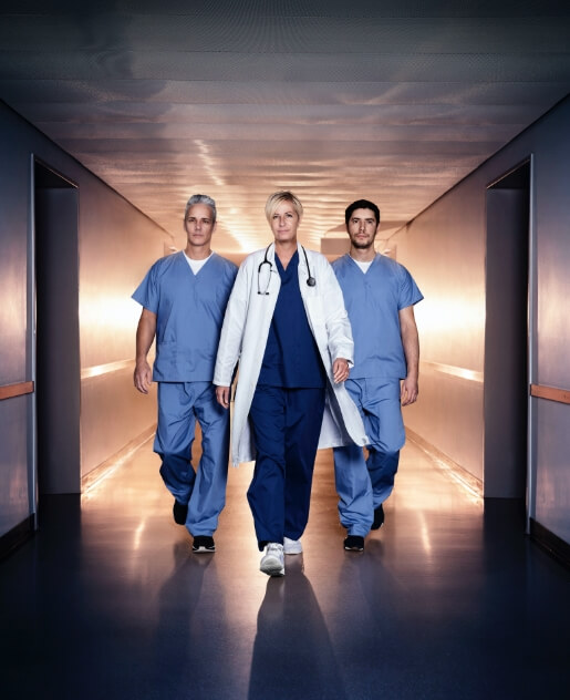 Doctor and two Nurses walking Down hospital Hallway