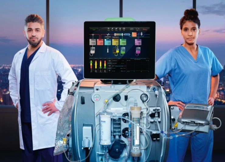 Doctor and nurse standing next to PrisMax 2 machine